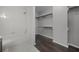 Bright bathroom featuring a shower-tub combo and spacious walk-in closet with wood shelving at 479 Cidermill Place, Lake Mary, FL 32746