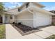 Exterior view of a cozy home with a two-car garage and a charming front yard at 479 Cidermill Place, Lake Mary, FL 32746