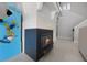 Living room fireplace and staircase next to the arcade game at 479 Cidermill Place, Lake Mary, FL 32746