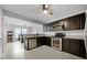 Contemporary kitchen featuring granite countertops, dark wood cabinets, and stainless steel appliances at 479 Cidermill Place, Lake Mary, FL 32746