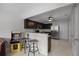 Modern kitchen featuring granite countertops, dark wood cabinets, and stainless steel appliances at 479 Cidermill Place, Lake Mary, FL 32746