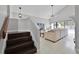 Staircase leading to a bright living room with a pool view and comfortable white furniture at 479 Cidermill Place, Lake Mary, FL 32746
