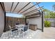 Outdoor patio area under a canvas roof featuring a table, chairs, and a storage bin at 479 Cidermill Place, Lake Mary, FL 32746