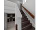 Staircase with dark wood steps and a view of the kitchen with stainless steel appliances at 479 Cidermill Place, Lake Mary, FL 32746