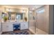 Modern bathroom with double vanity, a glass enclosed shower, and stylish blue rug at 4891 Lyric Dr, Mascotte, FL 34753
