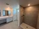 Bathroom featuring a tiled shower, vanity with sink, and ample counter space at 4891 Lyric Dr, Mascotte, FL 34753