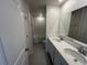Modern bathroom featuring double sinks, stylish fixtures, and a separate toilet and shower at 4891 Lyric Dr, Mascotte, FL 34753