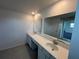 Bright bathroom with double sinks, ample counter space, and large mirror at 4891 Lyric Dr, Mascotte, FL 34753