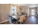 Elegant dining room with modern lighting, a wooden table and neutral decor at 4891 Lyric Dr, Mascotte, FL 34753