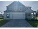 Beautiful two-story home featuring a well-manicured lawn and a paved driveway at 4891 Lyric Dr, Mascotte, FL 34753