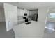 Modern kitchen with a large island, stainless steel appliances, and sleek white cabinetry at 4891 Lyric Dr, Mascotte, FL 34753