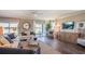 Open living room with lake views, neutral tones, a ceiling fan, and sliding glass doors at 4891 Lyric Dr, Mascotte, FL 34753