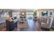 Spacious living room with wood floors, comfortable seating, and a sliding glass door to the backyard at 4891 Lyric Dr, Mascotte, FL 34753