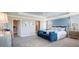 Tranquil main bedroom featuring a tray ceiling, blue accent wall, and a sitting area with comfortable bench at 4891 Lyric Dr, Mascotte, FL 34753
