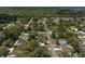 Aerial view of a quiet neighborhood with tree-lined streets and well-maintained homes offering a serene living environment at 714 Palmetto Ave, Orange City, FL 32763