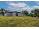 Newly constructed home with backyard lawn and dark roof at 714 Palmetto Ave, Orange City, FL 32763