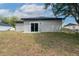 Home exterior showcases a sliding glass door and a spacious backyard at 714 Palmetto Ave, Orange City, FL 32763