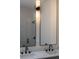 Close up view of a double vanity with black hardware and decorative sconces at 714 Palmetto Ave, Orange City, FL 32763