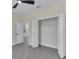 Bedroom features a ceiling fan, tiled floors, and a walk-in closet at 714 Palmetto Ave, Orange City, FL 32763