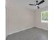 Bright bedroom with a ceiling fan and a window overlooking a green yard at 714 Palmetto Ave, Orange City, FL 32763
