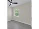Bedroom with a ceiling fan and natural light from a large window at 714 Palmetto Ave, Orange City, FL 32763