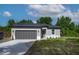 Charming single-story home featuring a two-car garage and a well-manicured lawn, blending comfort and curb appeal at 714 Palmetto Ave, Orange City, FL 32763