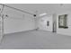 Large garage featuring epoxy flooring, ample space and a utility area at 714 Palmetto Ave, Orange City, FL 32763