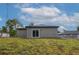Back of house with sliding glass door and newly installed dark roof at 714 Palmetto Ave, Orange City, FL 32763