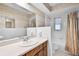 Bathroom featuring a single sink vanity, large mirror, and a shower/tub combo at 715 Roughbeard Rd, Winter Park, FL 32792