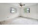 Spacious bedroom with a ceiling fan and natural light from two windows at 715 Roughbeard Rd, Winter Park, FL 32792