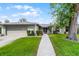 Charming single-story home with a well-manicured lawn and mature landscaping at 715 Roughbeard Rd, Winter Park, FL 32792