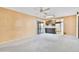Open living space next to the kitchen with ample natural light and a ceiling fan at 715 Roughbeard Rd, Winter Park, FL 32792
