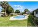 Backyard pool offers a serene escape with a seating area and lush greenery at 715 Roughbeard Rd, Winter Park, FL 32792