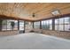 Bright sunroom with brick walls, ceiling fan, and many windows at 715 Roughbeard Rd, Winter Park, FL 32792