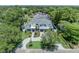 A sprawling home with an elegant driveway, lush landscaping, and a three-car garage at 731 Williams Dr, Winter Park, FL 32789