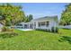 An immaculate backyard features a covered patio and pristine pool perfect for relaxing and entertaining at 731 Williams Dr, Winter Park, FL 32789