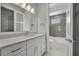 Bathroom featuring a sleek vanity, large mirror, and a shower-tub combination for relaxation at 731 Williams Dr, Winter Park, FL 32789