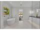 Bright bathroom featuring a soaking tub, and dual sinks with a view to the bedroom at 731 Williams Dr, Winter Park, FL 32789
