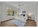Bright bedroom with hardwood floors, a ceiling fan, and a large window with a view at 731 Williams Dr, Winter Park, FL 32789