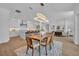 Bright open floor plan with a modern dining room set and views of the kitchen and living area at 731 Williams Dr, Winter Park, FL 32789