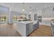 Open floor plan kitchen with white cabinets, a spacious island, stainless appliances, and views to the pool and patio at 731 Williams Dr, Winter Park, FL 32789
