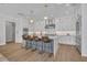 Gourmet kitchen featuring white cabinets, stainless steel appliances, a subway tile backsplash, and a large island at 731 Williams Dr, Winter Park, FL 32789