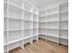 A walk-in pantry with custom built-in shelves and hardwood floors offers an abundance of storage at 731 Williams Dr, Winter Park, FL 32789