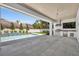 A luxurious outdoor pool area with a built-in stainless grill and tiled patio for relaxing and entertaining at 731 Williams Dr, Winter Park, FL 32789