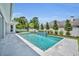 Sparkling pool with a blue tile waterfall feature and meticulously landscaped garden at 731 Williams Dr, Winter Park, FL 32789