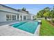 An inviting pool area with lush green grass, a sparkling pool, and a modern home at 731 Williams Dr, Winter Park, FL 32789