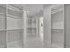 Expansive walk-in closet featuring ample shelving and storage solutions with access to the bathroom at 731 Williams Dr, Winter Park, FL 32789