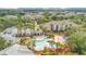 Stunning aerial view of the neighborhood pool, clubhouse and lush tropical landscaping at 8908 Legacy Ct # 303, Kissimmee, FL 34747
