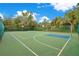 Outdoor basketball court with a lush tropical tree line at 8908 Legacy Ct # 303, Kissimmee, FL 34747