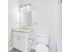 A bright bathroom featuring a granite-topped vanity, mirror, and a combo shower-tub at 8908 Legacy Ct # 303, Kissimmee, FL 34747